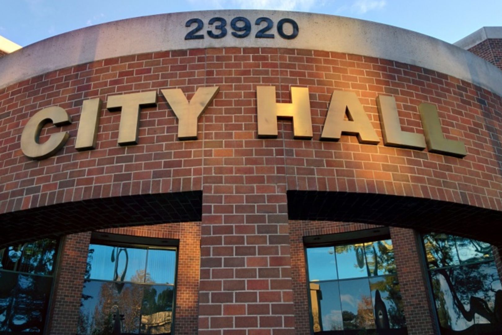 A building that has the city hall sign on it.