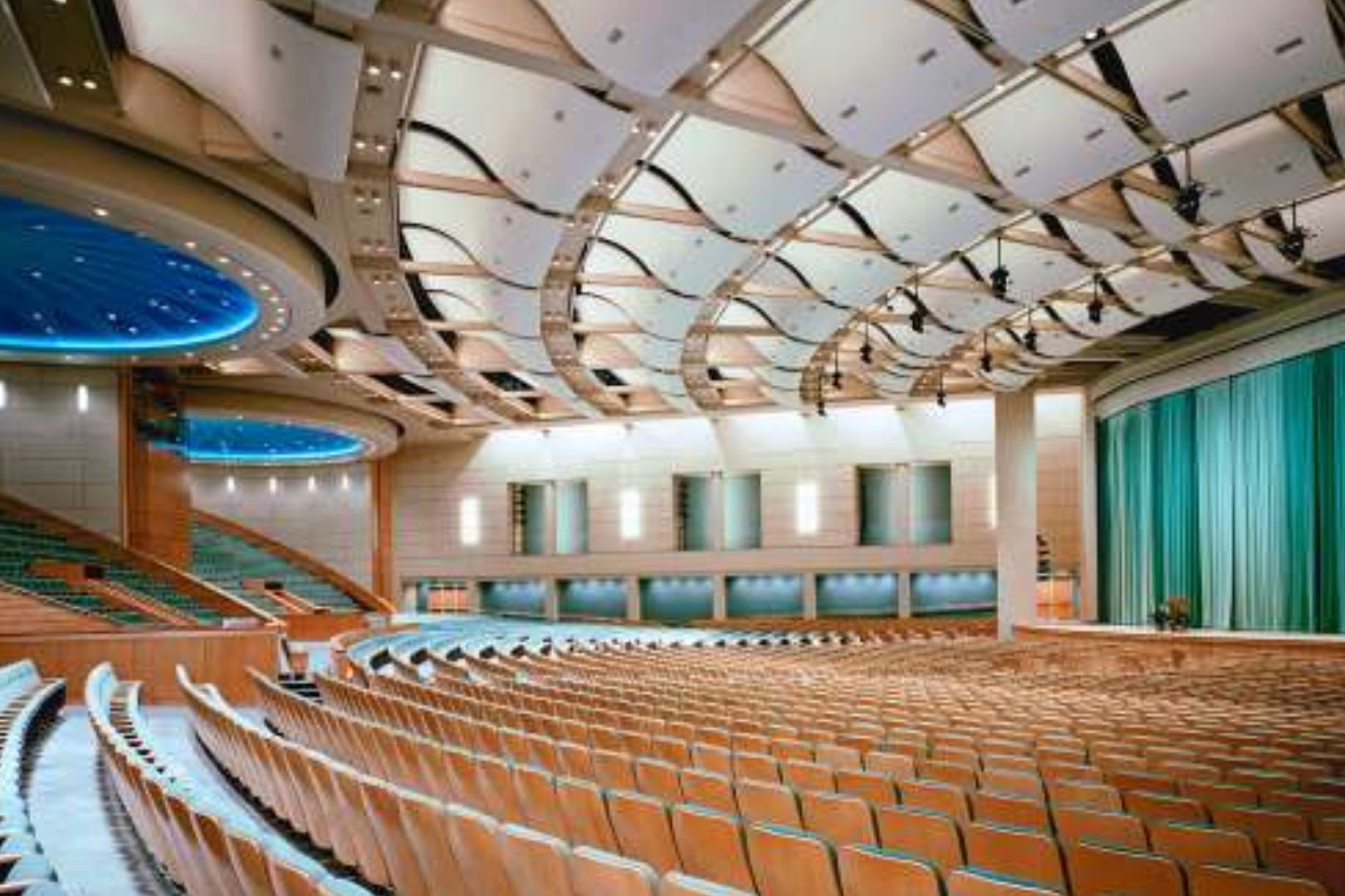 A large auditorium with rows of seats and a ceiling.