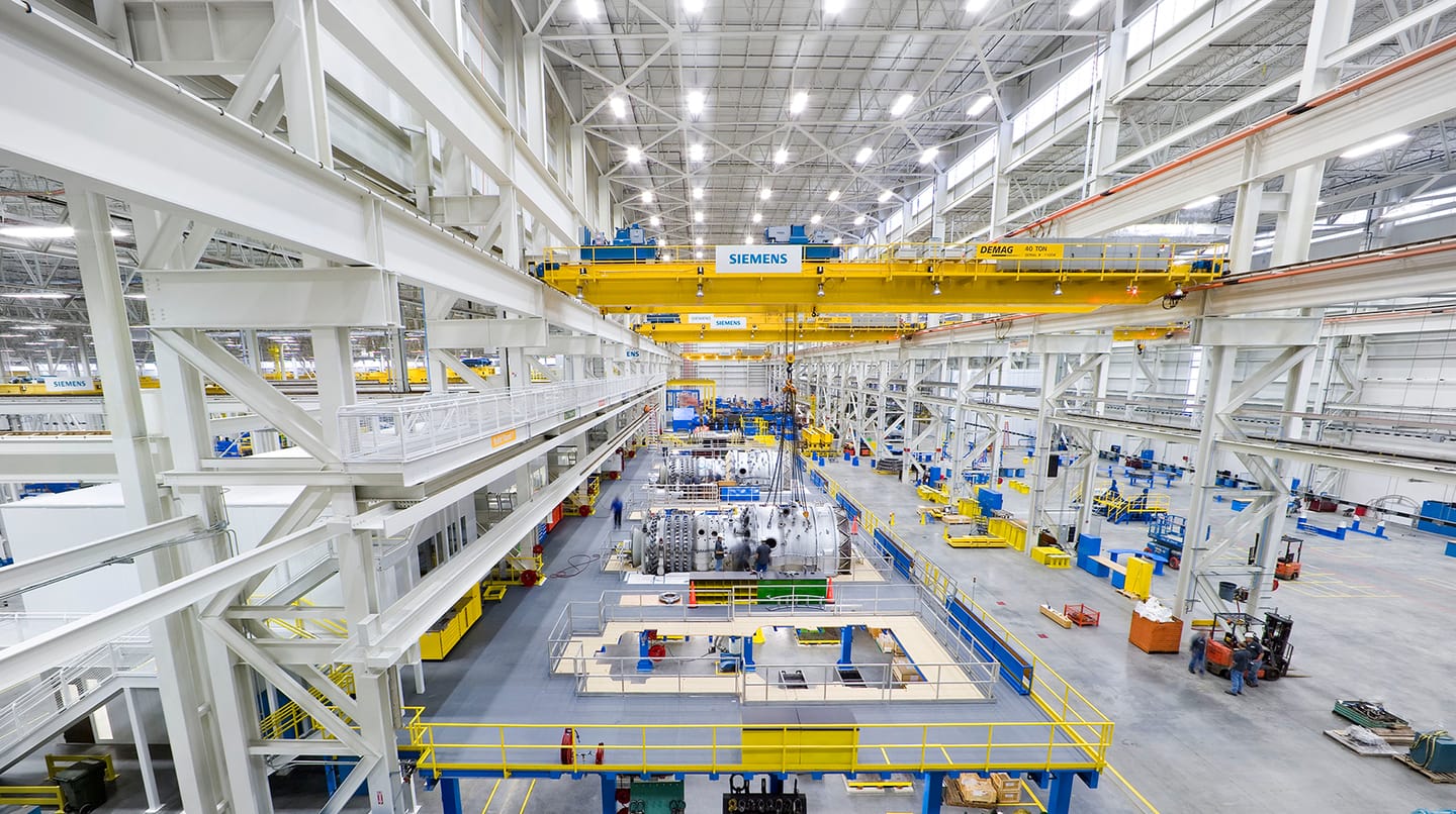 A large warehouse with workers in it.