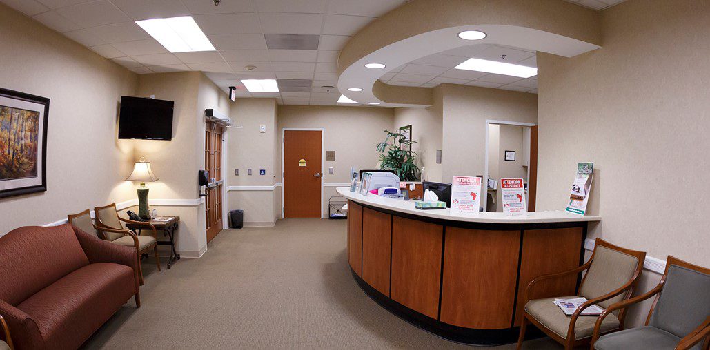 A hospital reception area with the door open.