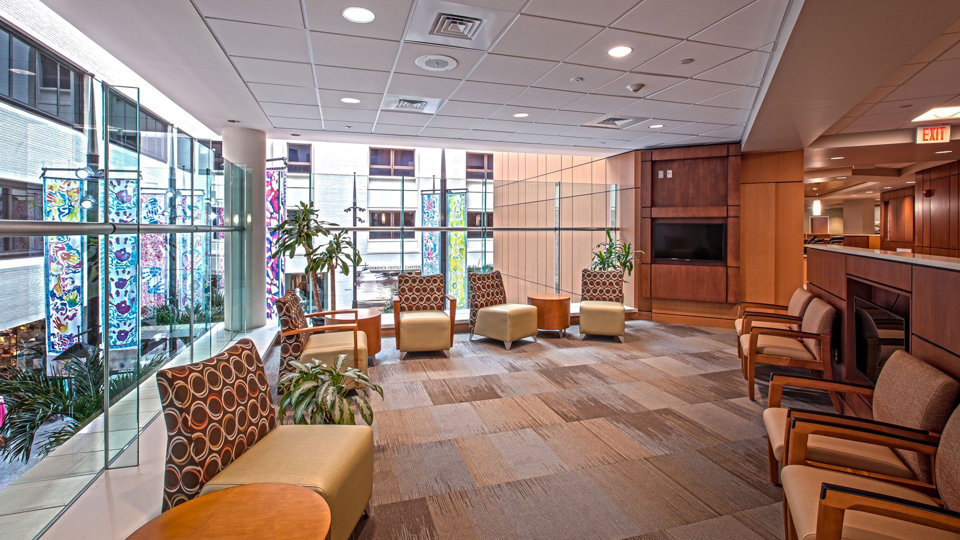 A lobby with several chairs and tables in it.