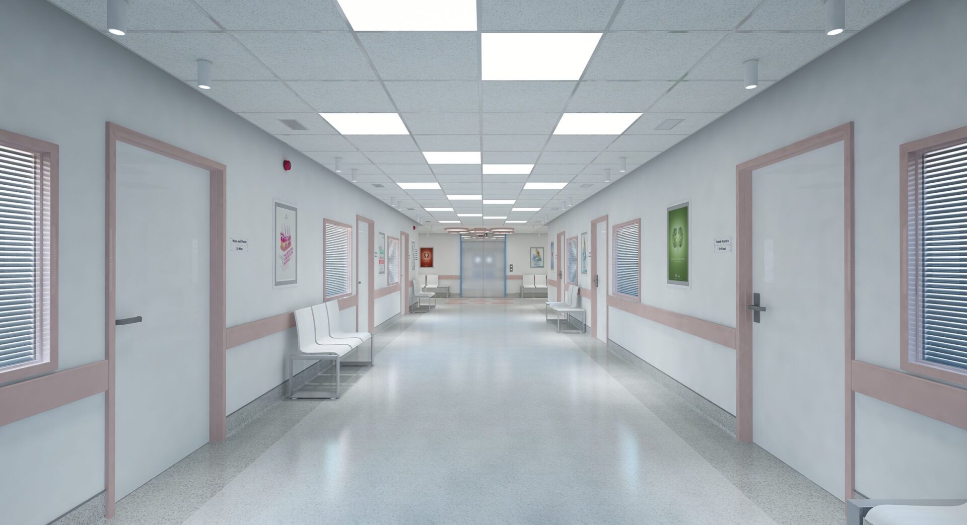 A hospital hallway with white walls and pink trim.