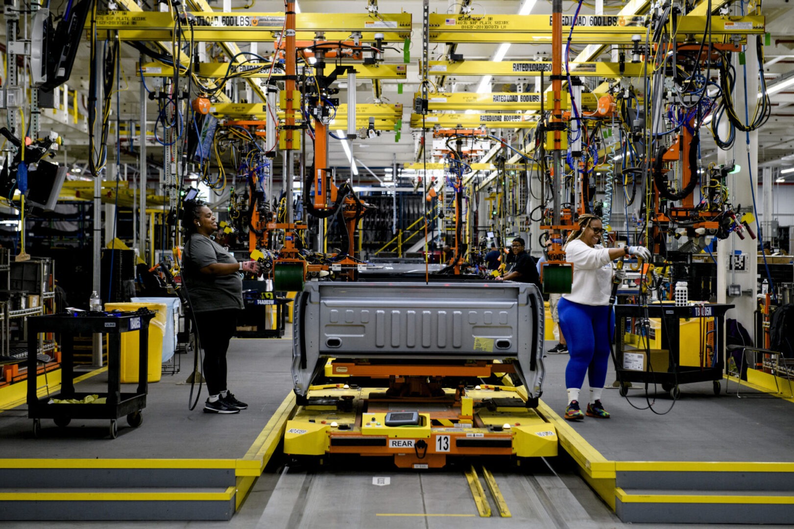 A truck being worked on in an assembly line.