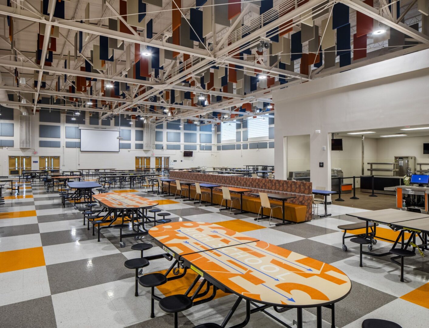 A cafeteria with tables and chairs in it