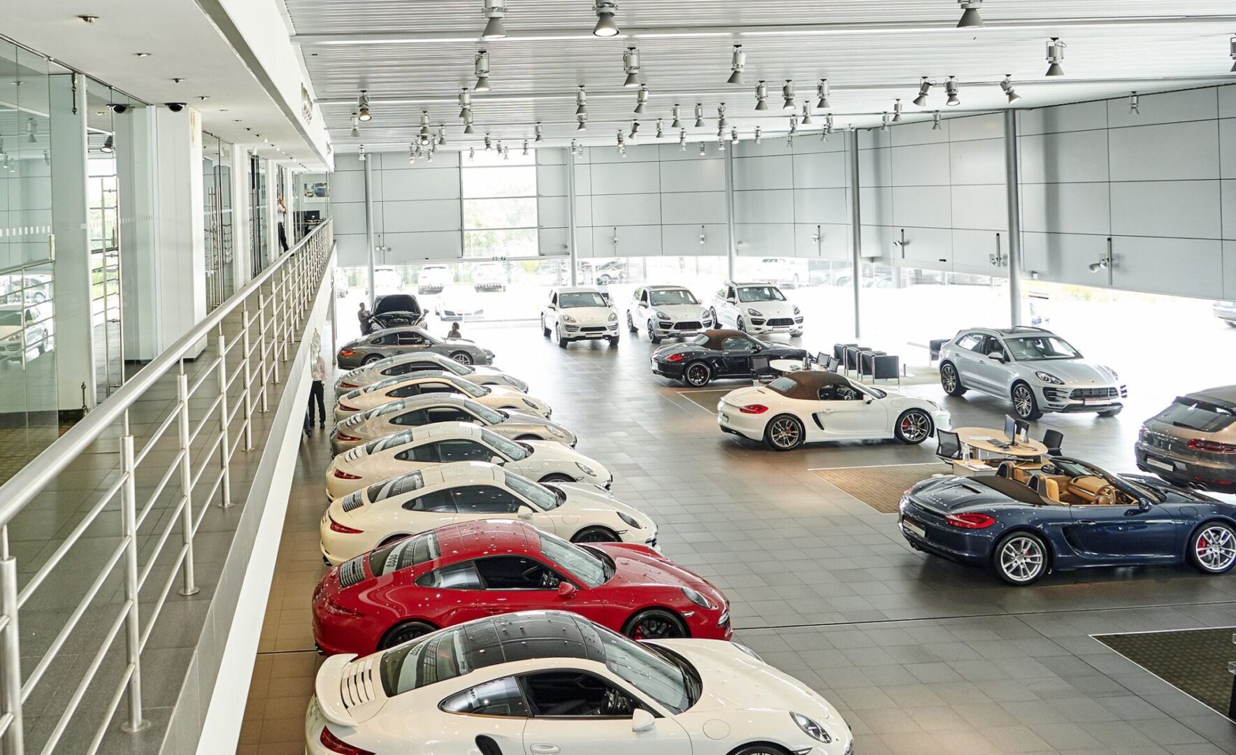 A large group of cars parked in a showroom.