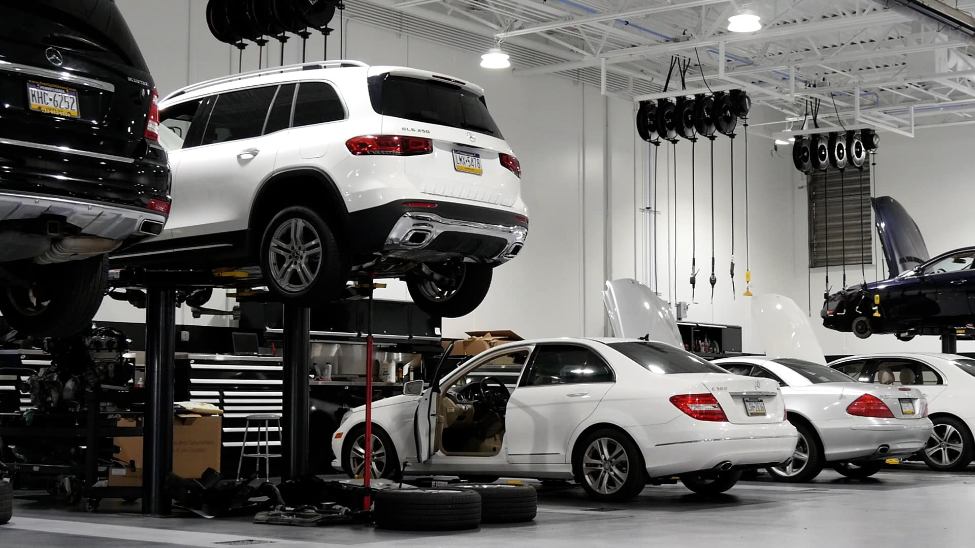 A car shop with several cars on the top of each one.