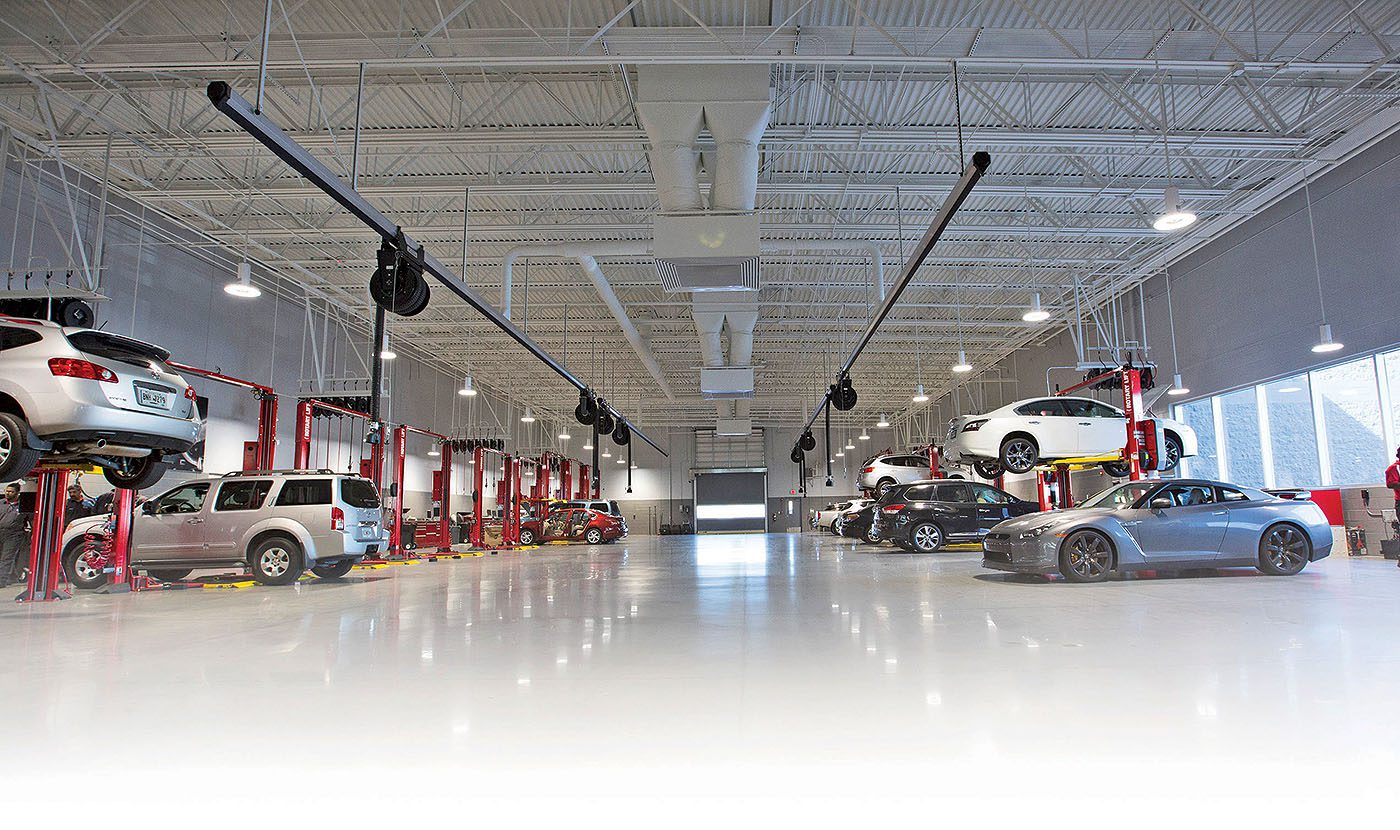 A large garage with many cars parked in it.