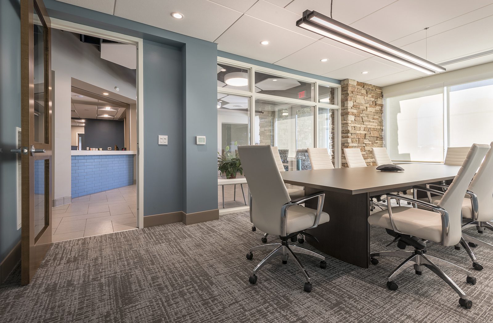 A conference room with a table and chairs