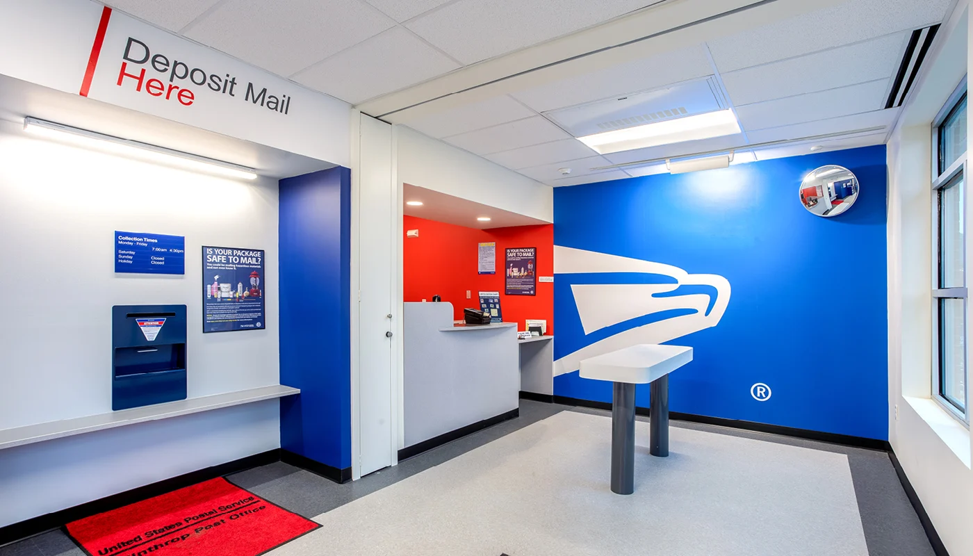 A mail room with a desk and a counter.