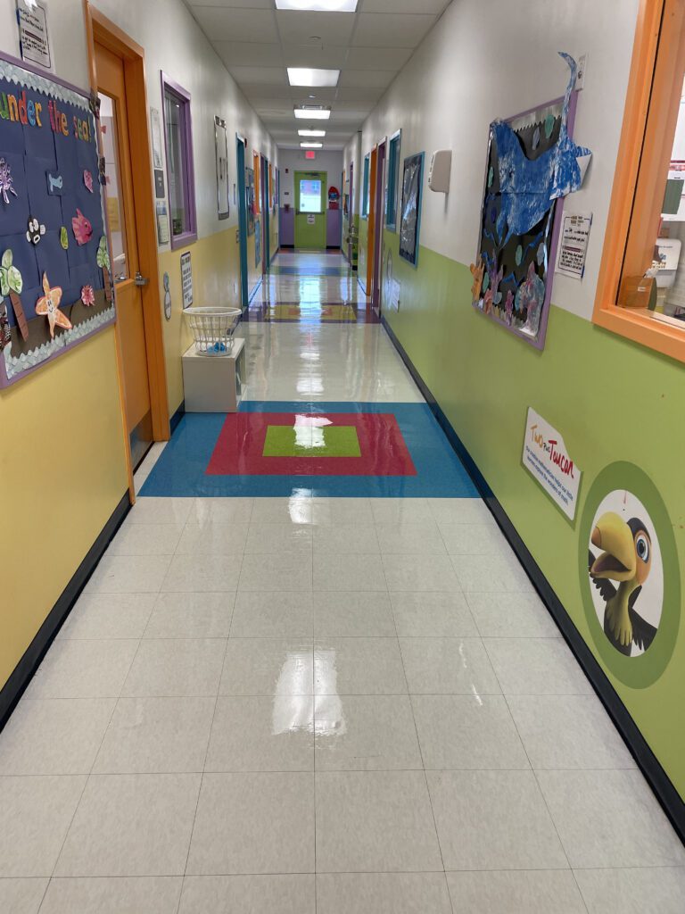A hallway with a wall mural and a rug.