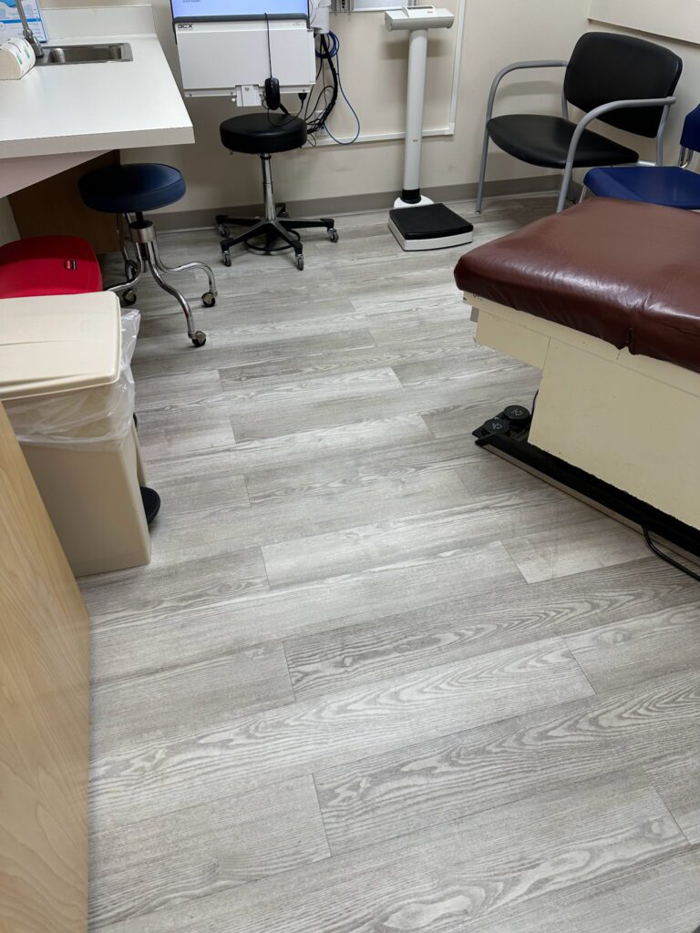 A room with wooden floors and a brown chair.