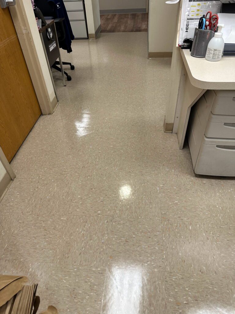 A clean room with the door open and the floor.