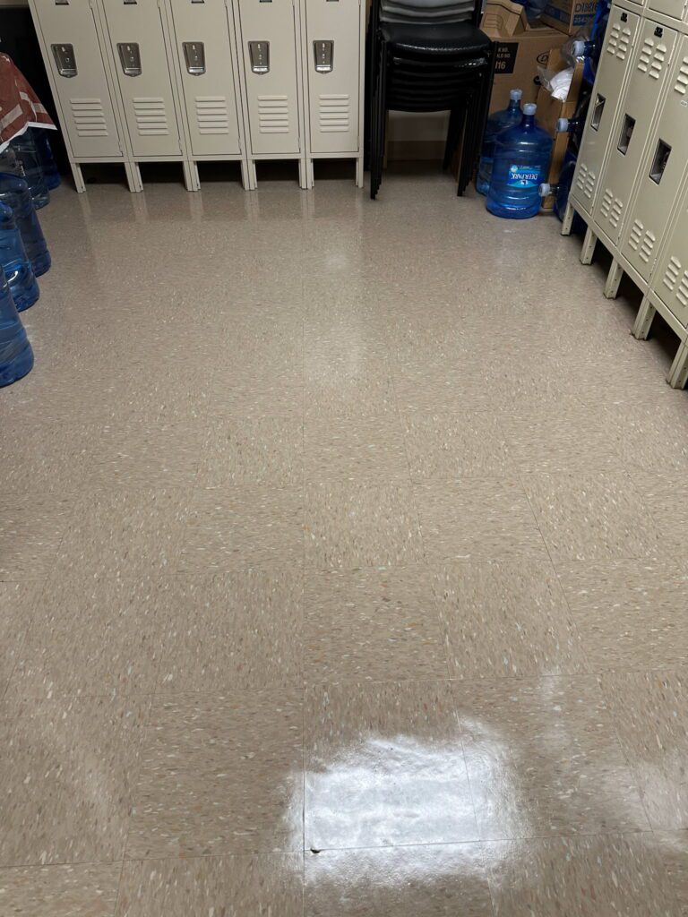 A room with two blue water jugs on the floor.