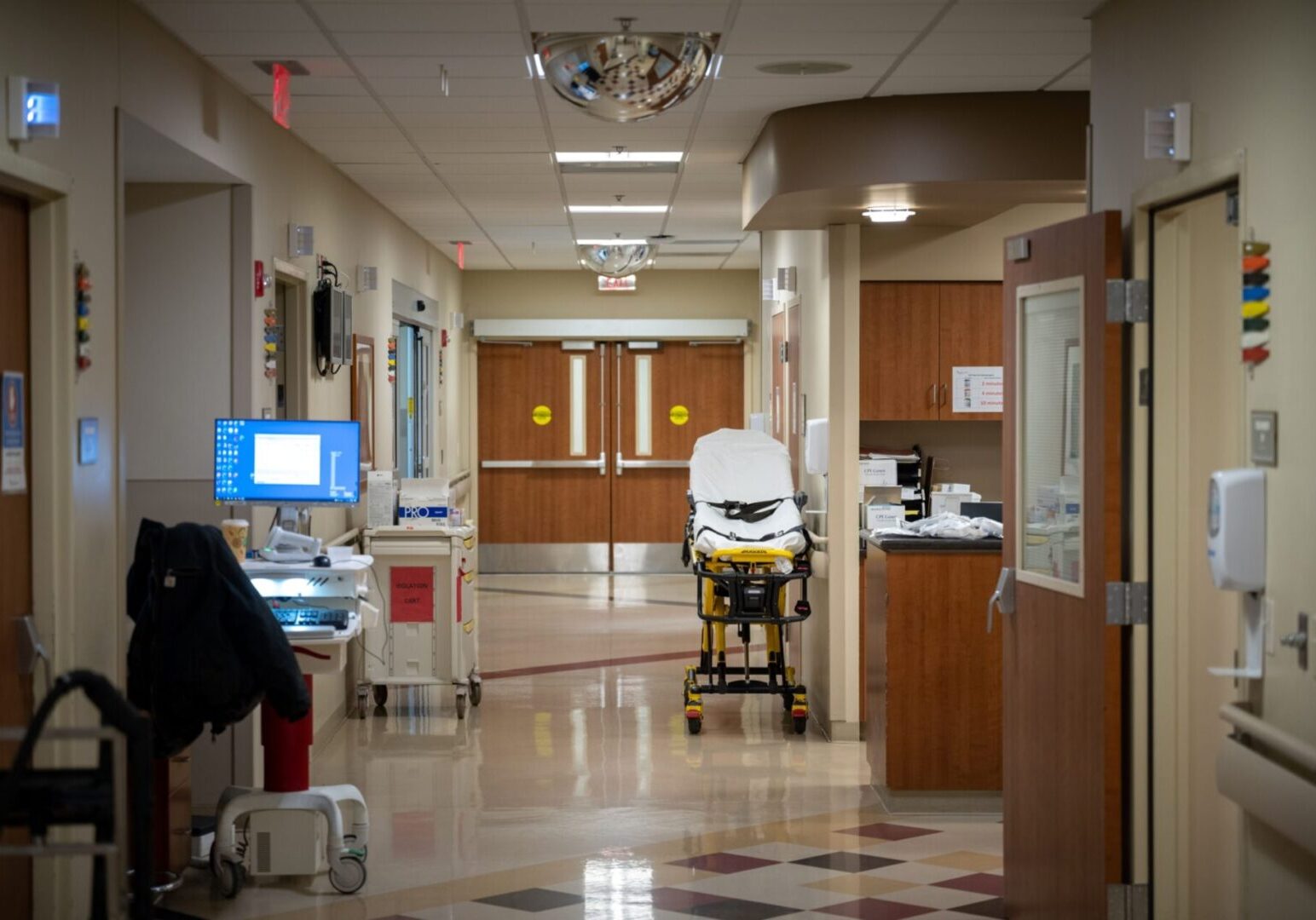 A hospital room with a patient in the back of an ambulance.